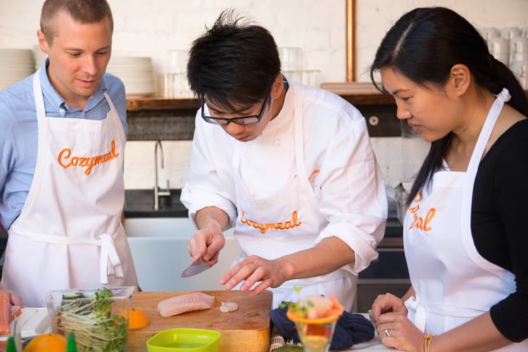 Couple learning holiday recipes in a Cozymeal cooking class with a local chef.